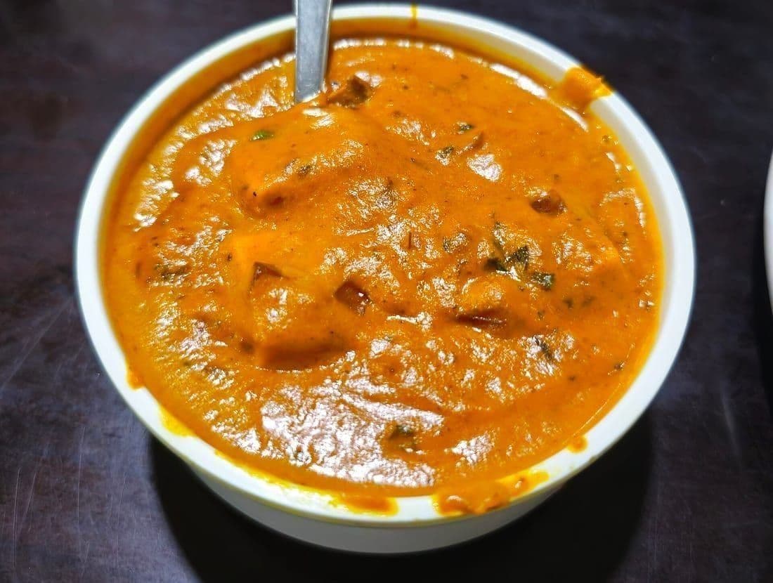 Paneer butter masala in a copper handi