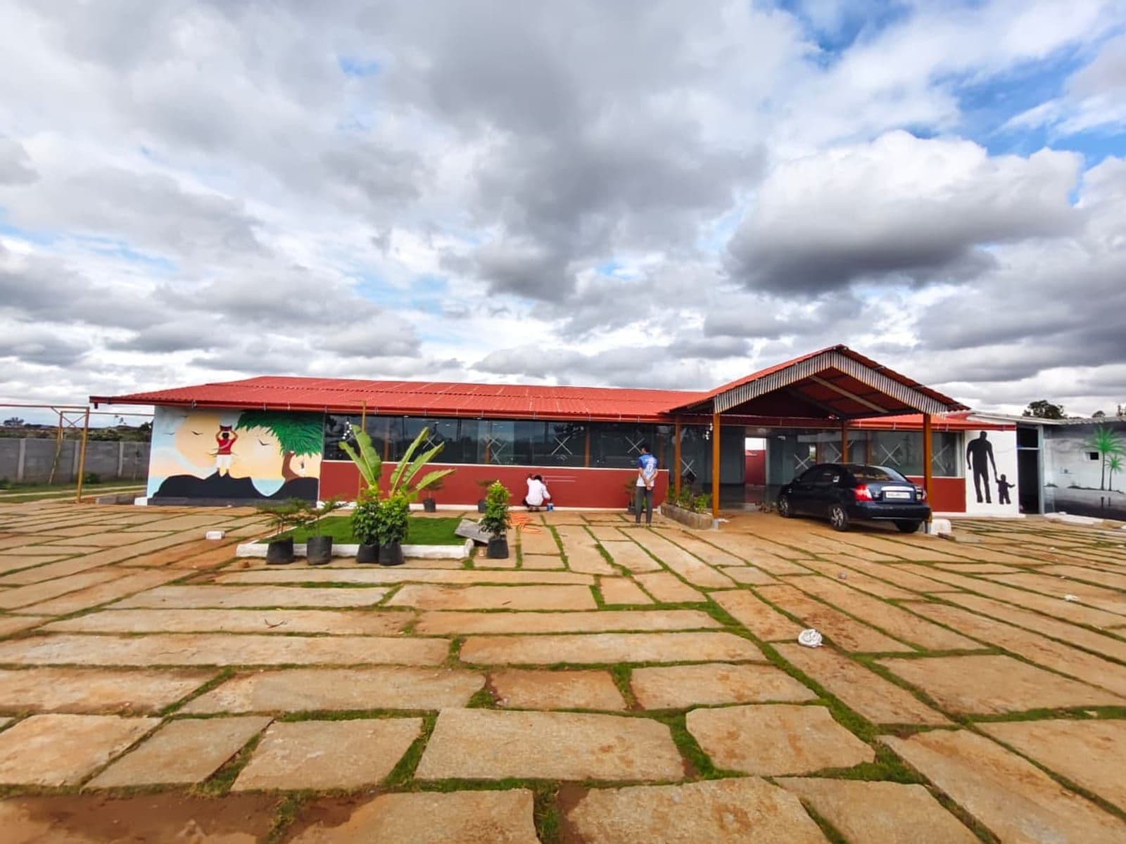 The Next Level Family Restaurant building with its red roof and painted mural wall
