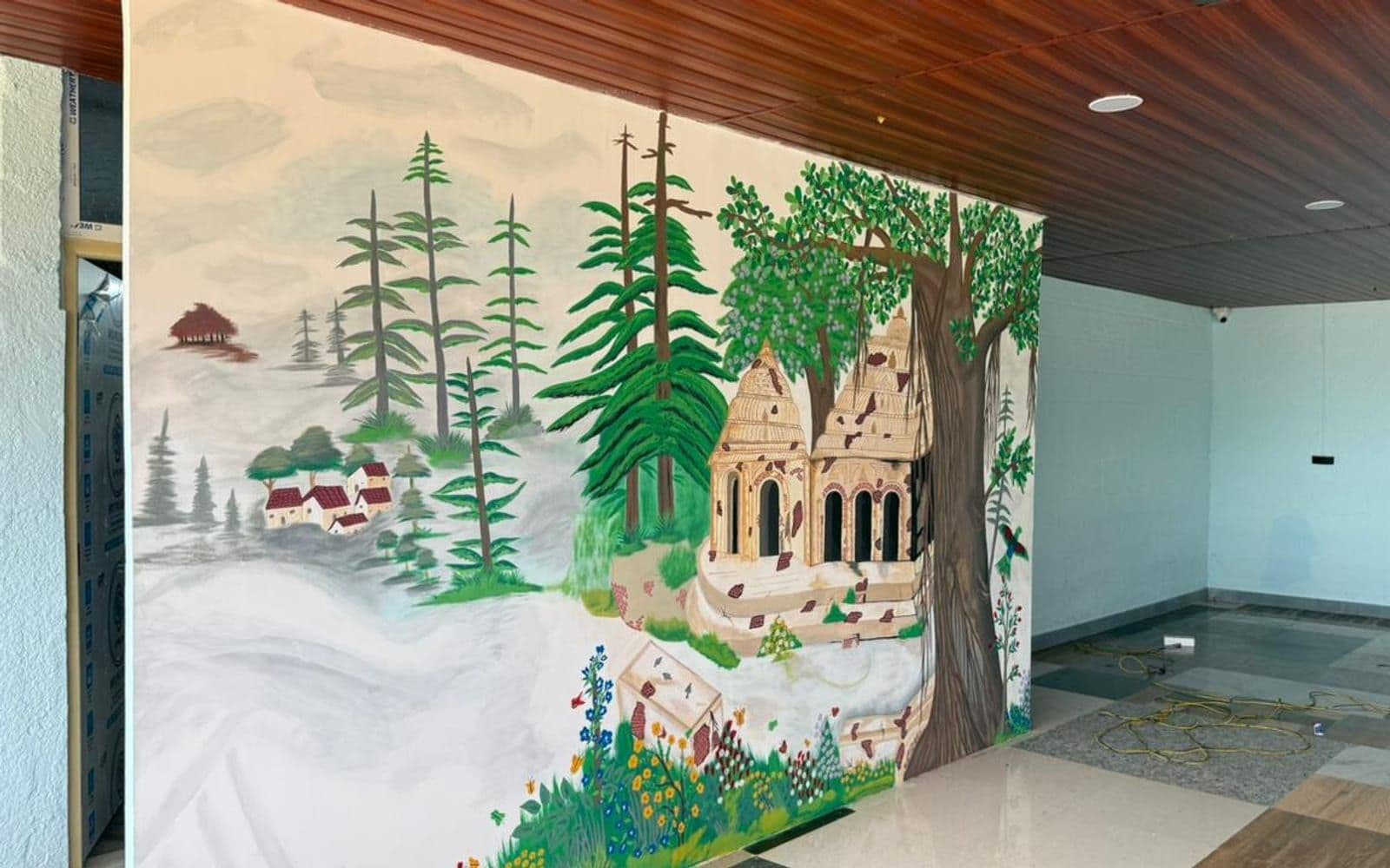 Dining hall with a hand-painted temple-and-forest mural and wood-panelled ceiling